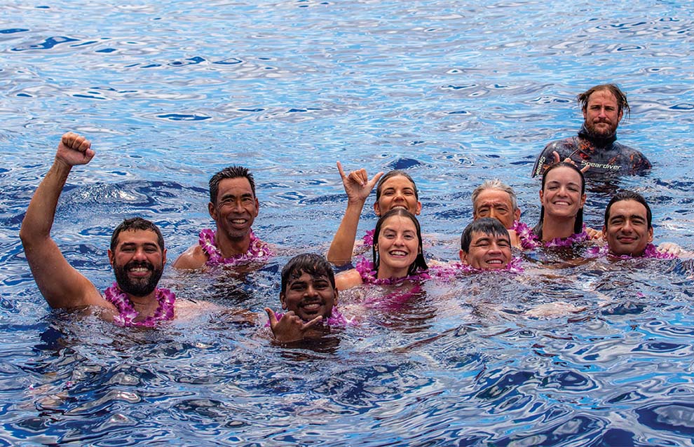 a group of people cheering while in the water